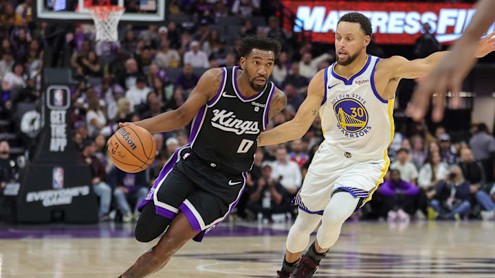 Oct 27, 2023; Sacramento, California, USA; Sacramento Kings guard Malik Monk (0) dribbles the ball past Golden State Warriors guard Stephen Curry (30) during the second quarter at Golden 1 Center. Mandatory Credit: Sergio Estrada-Imagn Images Oct 27, 2023; Sacramento, California, USA; Sacramento Kings guard Malik Monk (0) dribbles the ball past Golden State Warriors guard Stephen Curry (30) during the second quarter at Golden 1 Center. Mandatory Credit: Sergio Estrada-Imagn Images