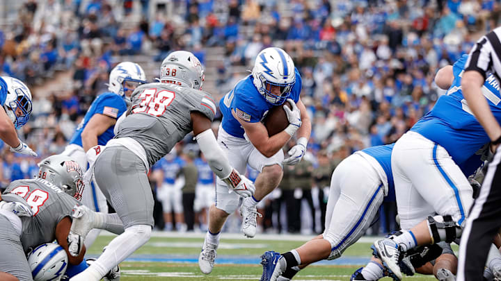 Air Force Falcons running back Dylan Carson (20) runs the ball as UNLV Rebels linebacker Marsel McDuffie (38) defends in the first quarter at Falcon Stadium. 