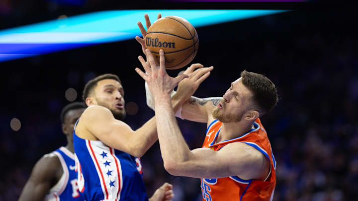 Jan 14, 2025; Philadelphia, Pennsylvania, USA; Oklahoma City Thunder center Isaiah Hartenstein (55) and Philadelphia 76ers Pete Nance (22) battle for a rebound during the fourth quarter at Wells Fargo Center. Mandatory Credit: Bill Streicher-Imagn Images