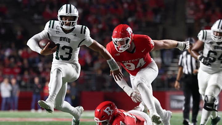 Aug 28, 2025; Piscataway, New Jersey, USA;  Ohio Bobcats quarterback Parker Navarro (13) scores a rushing touchdown as Rutgers Scarlet Knights defensive lineman Jordan Thompson (14) and defensive lineman Bradley Weaver (94) pursue during the second half at SHI Stadium. Mandatory Credit: Vincent Carchietta-Imagn Images