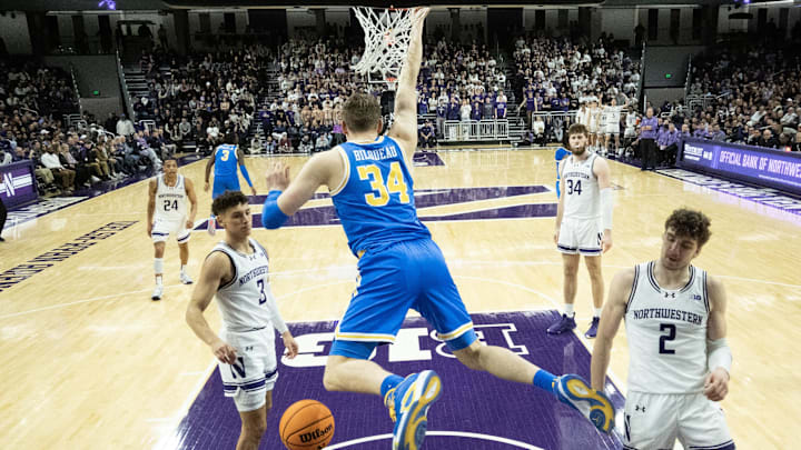 Mar 3, 2025; Evanston, Illinois, USA; UCLA Bruins forward Tyler Bilodeau (34) dunks the ball on Northwestern Wildcats forward Nick Martinelli (2) during the second half at Welsh-Ryan Arena. Mandatory Credit: David Banks-Imagn Images