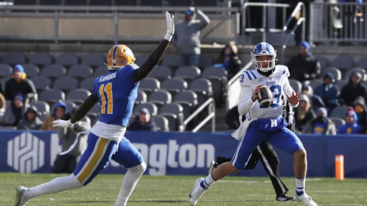 Nov 19, 2022; Pittsburgh, Pennsylvania, USA;  Duke Blue Devils quarterback Riley Leonard (13) looks to pass the ball as Pittsburgh Panthers linebacker Bangally Kamara (11) defends during the second quarter at Acrisure Stadium. Mandatory Credit: Charles LeClaire-Imagn Images