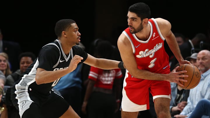 Mar 1, 2025; Memphis, Tennessee, USA; Memphis Grizzlies forward Santi Aldama (7) handles the ball as San Antonio Spurs forward Keldon Johnson (0) defends during the fourth quarter at FedExForum. Mandatory Credit: Petre Thomas-Imagn Images