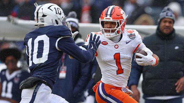 Dec 27, 2025; Bronx, NY, USA; Clemson Tigers wide receiver T.J. Moore (1) fights for yards against Penn State Nittany Lions safety Dejuan Lane (10) during the first half of the 2025 Pinstripe Bowl at Yankee Stadium. Mandatory Credit: Vincent Carchietta-Imagn Images