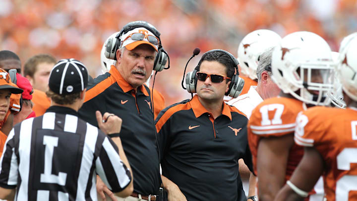 Oct 8, 2011; Dallas, TX, USA; Texas Longhorns assistant head coach Duane Akina and defensive coordinator Manny Diaz on the sidelines during the second quarter against the Oklahoma Sooners for the red river rivalry at the Cotton Bowl. Mandatory Credit: Matthew Emmons-Imagn Images Oct 8, 2011; Dallas, TX, USA; Texas Longhorns assistant head coach Duane Akina and defensive coordinator Manny Diaz on the sidelines during the second quarter against the Oklahoma Sooners for the red river rivalry at the Cotton Bowl. Mandatory Credit: Matthew Emmons-Imagn Images