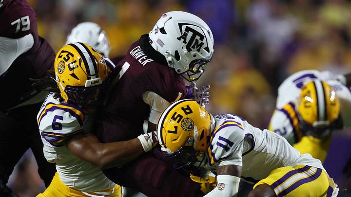 Sep 26, 2026; Baton Rouge, Louisiana, USA; Texas A&M Aggies wide receiver Mario Craver (1) is tackled by LSU Tigers linebacker TJ Dottery (6) and cornerback PJ Woodland (11) during the second quarter at Tiger Stadium. Mandatory Credit: Stephen Lew-Imagn Images Sep 26, 2026; Baton Rouge, Louisiana, USA; Texas A&M Aggies wide receiver Mario Craver (1) is tackled by LSU Tigers linebacker TJ Dottery (6) and cornerback PJ Woodland (11) during the second quarter at Tiger Stadium. Mandatory Credit: Stephen Lew-Imagn Images