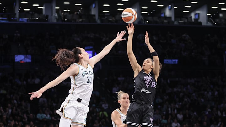 May 27, 2025; Brooklyn, New York, USA;  Golden State Valkyries forward Janelle Salaun (13) takes a three point shot past New York Liberty forward Breanna Stewart (30) in the first quarter at Barclays Center. Mandatory Credit: Wendell Cruz-Imagn Images