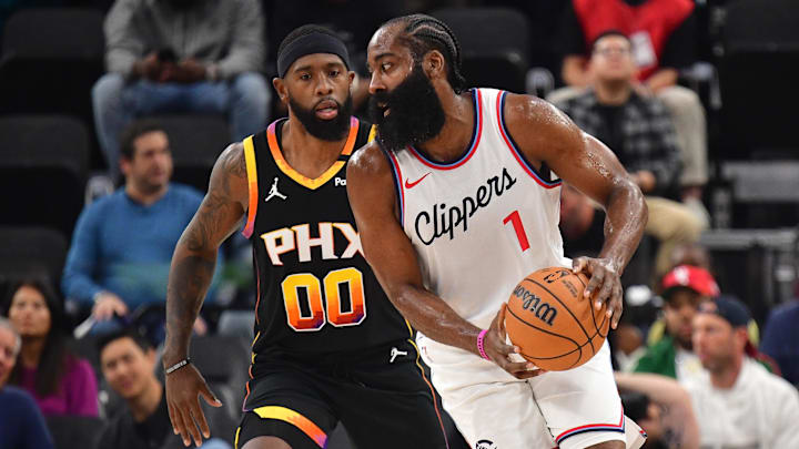 Oct 31, 2024; Inglewood, California, USA; Los Angeles Clippers guard James Harden (1) moves the ball against Phoenix Suns forward Royce O'Neale (00) during the first half at Intuit Dome. Mandatory Credit: Gary A. Vasquez-Imagn Images
