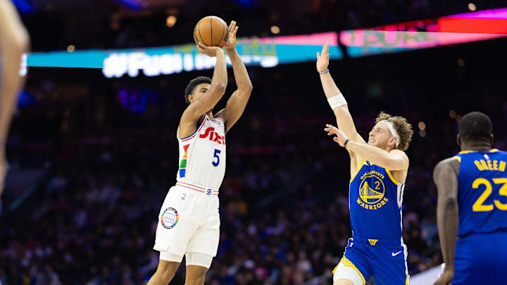 Mar 1, 2025; Philadelphia, Pennsylvania, USA; Philadelphia 76ers guard Quentin Grimes (5) shoots past Golden State Warriors guard Brandin Podziemski (2) during the second quarter at Wells Fargo Center. Mandatory Credit: Bill Streicher-Imagn Images
