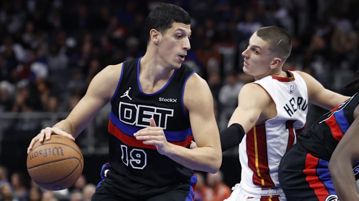Nov 12, 2024; Detroit, Michigan, USA;  Detroit Pistons forward Simone Fontecchio (19) dribbles defended by Miami Heat guard Tyler Herro (14) in the second half at Little Caesars Arena. Mandatory Credit: Rick Osentoski-Imagn Images