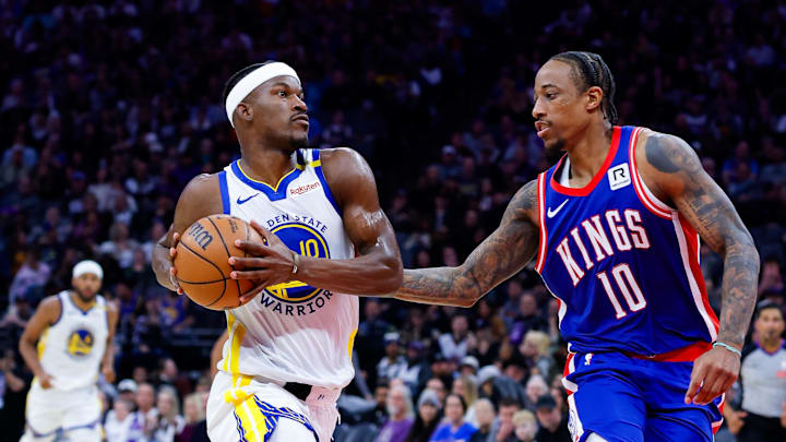 Feb 21, 2025; Sacramento, California, USA; Golden State Warriors forward Jimmy Butler III (10) drives to the basket against Sacramento Kings forward DeMar DeRozan (10) during the fourth quarter at Golden 1 Center. Mandatory Credit: Sergio Estrada-Imagn Images