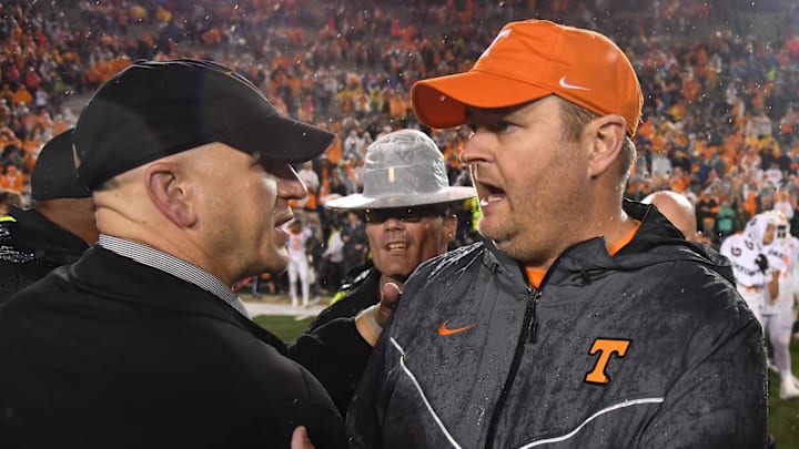 Nov 26, 2022; Nashville, Tennessee, USA; Vanderbilt Commodores head coach Clark Lea and Tennessee Volunteers head coach Josh Heupel meet at mid field after a shutout win by the Volunteers at FirstBank Stadium. Mandatory Credit: Christopher Hanewinckel-Imagn Images