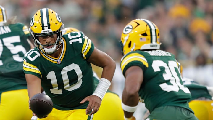 Green Bay Packers quarterback Jordan Love (10) hands off the ball to running back Chris Brooks (30) against the Jets during their football game Saturday, August 9, 2025, at Lambeau Field in Green Bay, Wisconsin.