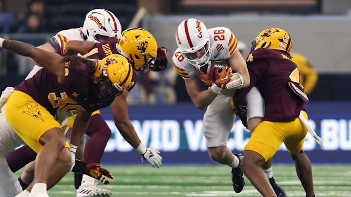Dec 7, 2024; Arlington, TX, USA; Iowa State Cyclones running back Carson Hansen (26) runs the ball against Arizona State Sun Devils defensive back Myles Rowser (4) in the first quarter at AT&T Stadium. Mandatory Credit: Tim Heitman-Imagn Images Dec 7, 2024; Arlington, TX, USA; Iowa State Cyclones running back Carson Hansen (26) runs the ball against Arizona State Sun Devils defensive back Myles Rowser (4) in the first quarter at AT&T Stadium. Mandatory Credit: Tim Heitman-Imagn Images