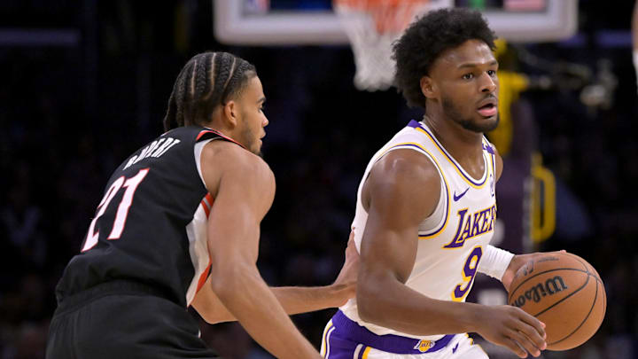 Dec 8, 2024; Los Angeles, California, USA;  Los Angeles Lakers guard Bronny James (9) is defended by Portland Trail Blazers guard Rayan Rupert (21) in the second half at Crypto.com Arena. Mandatory Credit: Jayne Kamin-Oncea-Imagn Images
