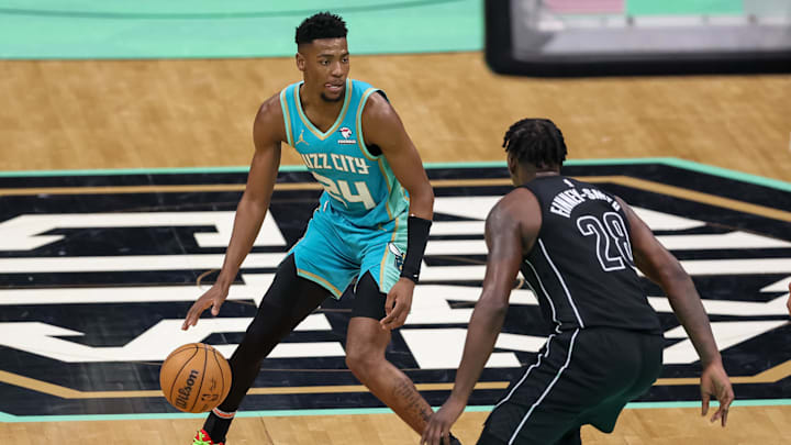 Mar 9, 2024; Charlotte, North Carolina, USA;  Charlotte Hornets forward Brandon Miller (24) sets the play against Brooklyn Nets forward Dorian Finney-Smith (28) during the fourth quarter at Spectrum Center. Mandatory Credit: Cory Knowlton-Imagn Images