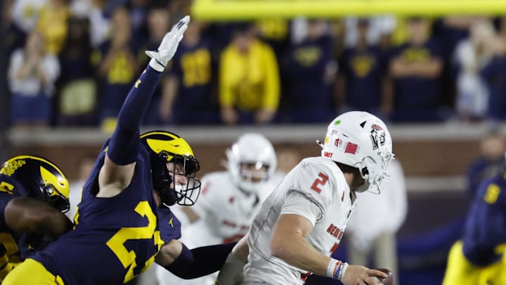 Aug 30, 2025; Ann Arbor, Michigan, USA;  Michigan Wolverines linebacker Cole Sullivan (23) sacks New Mexico Lobos quarterback Jack Layne (2) in the second half at Michigan Stadium. Mandatory Credit: Rick Osentoski-Imagn Images