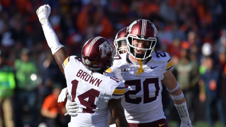 Nov 2, 2024; Champaign, Illinois, USA;  Minnesota Golden Gophers defensive back Kerry Brown (14) and Minnesota Golden Gophers defensive back Jack Henderson (20) celebrate a stop on the Illinois Fighting Illini during the second half at Memorial Stadium. Mandatory Credit: Ron Johnson-Imagn Images