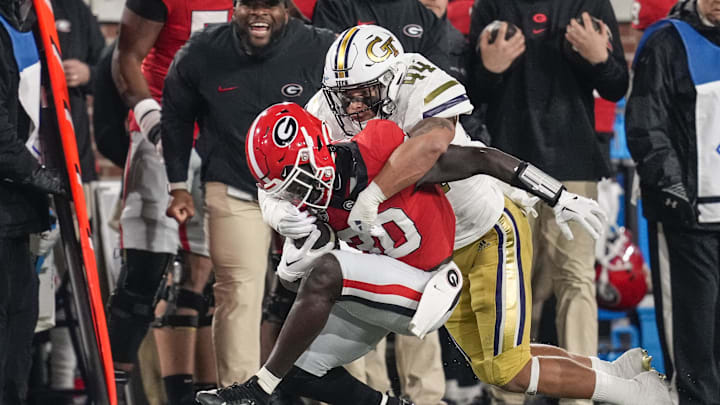 Nov 25, 2023; Atlanta, Georgia, USA; Georgia Bulldogs running back Daijun Edwards (30) is tackled by Georgia Tech Yellow Jackets linebacker Kyle Efford (44) during the first half at Hyundai Field. Mandatory Credit: Dale Zanine-Imagn Images