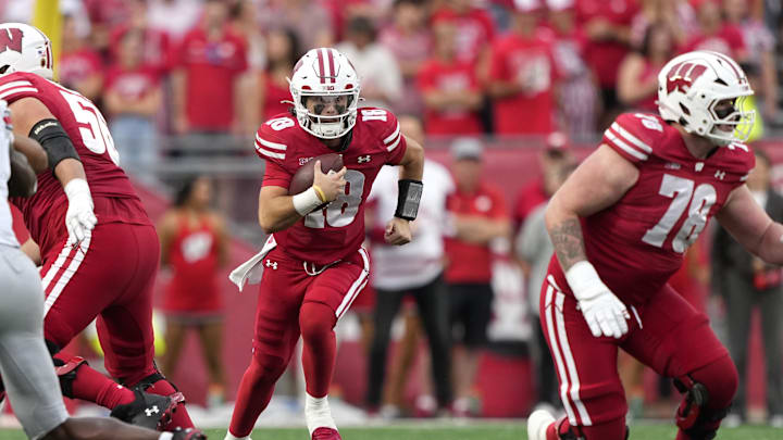 Oct 18, 2025; Madison, Wisconsin, USA; Wisconsin Badgers quarterback Danny O'Neil (18) runs against the Ohio State Buckeyes in the second half at Camp Randall Stadium. Mandatory Credit: Jeff Hanisch-Imagn Images