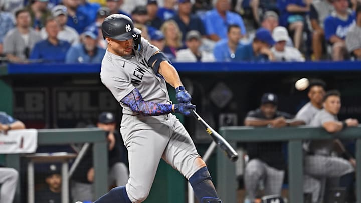 Jun 11, 2024; Kansas City, Missouri, USA; New York Yankees designated hitter Giancarlo Stanton (27) hits a solo home run in the seventh inning against the Kansas City Royals at Kauffman Stadium. Mandatory Credit: Peter Aiken-USA TODAY Sports