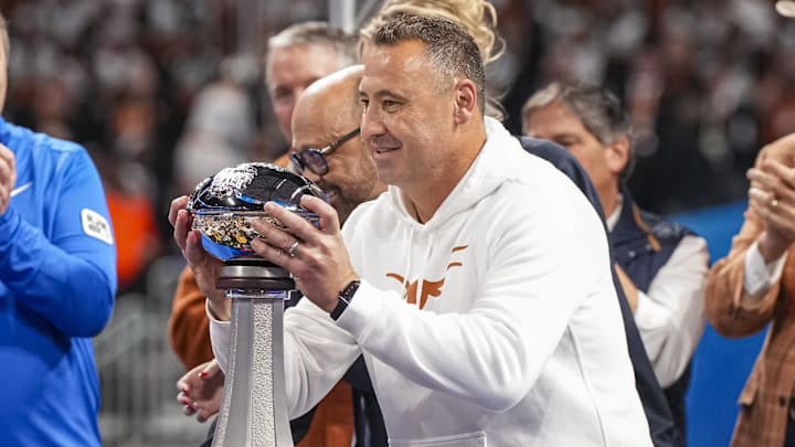 Jan 1, 2025; Atlanta, GA, USA; Texas Longhorns head coach Steve Sarkisian lifts the trophy after defeating the Arizona State Sun Devils at Mercedes-Benz Stadium. Mandatory Credit: Dale Zanine-Imagn Images