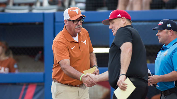 Jun 5, 2025; Oklahoma City, OK, USA;  Texas Longhorns head coach Mike White and Texas Tech Red Raiders head coach Gerry Glasco shake hands before game two of the NCAA Softball Women's College World Series finals at Devon Park. Mandatory Credit: Brett Rojo-Imagn Images