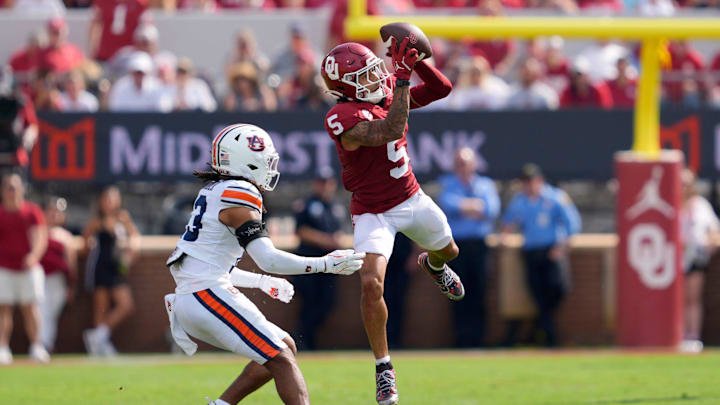 Oklahoma Sooners wide receiver Isaiah Sategna III (5) catches pass beside Auburn Tigers cornerback Raion Strader (13) during a college football game between the University of Oklahoma Sooners (OU) and the Auburn Tigers at Gaylord Family Ð Oklahoma Memorial Stadium in Norman, Okla., Saturday, Sept. 20, 2025.