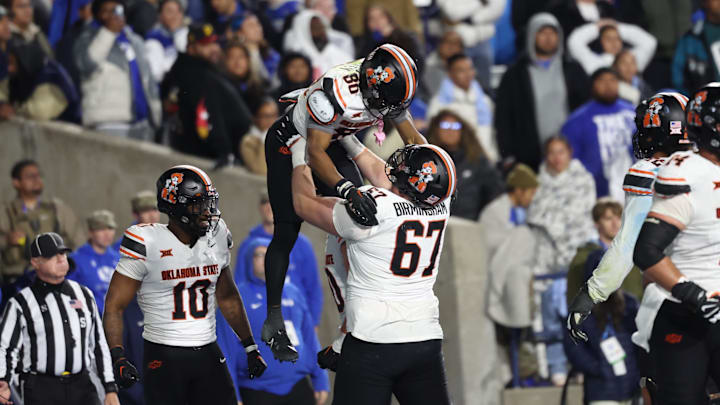 Oct 18, 2024; Provo, Utah, USA; Oklahoma State Cowboys wide receiver Brennan Presley (80) scores a touchdown against the Brigham Young Cougars and is held up by Oklahoma State Cowboys offensive lineman Cole Birmingham (67) during the fourth quarter at LaVell Edwards Stadium. Mandatory Credit: Rob Gray-Imagn Images