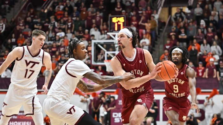 Mar 3, 2026; Blacksburg, Virginia, USA; Boston College Eagles center Boden Kapke (33) looks to pass as Virginia Tech Hokies forward Tobi Lawal (1) defends during the first half at Cassell Coliseum. Mandatory Credit: Brian Bishop-Imagn Images Mar 3, 2026; Blacksburg, Virginia, USA; Boston College Eagles center Boden Kapke (33) looks to pass as Virginia Tech Hokies forward Tobi Lawal (1) defends during the first half at Cassell Coliseum. Mandatory Credit: Brian Bishop-Imagn Images