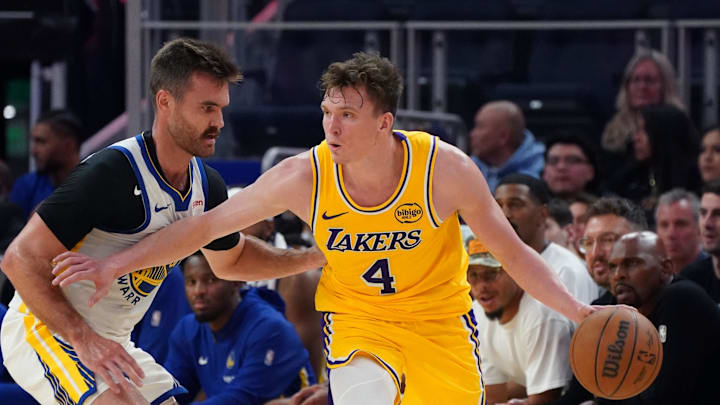 Oct 5, 2025; San Francisco, California, USA;  Los Angeles Lakers forward Dalton Knecht (4) is defended by Golden State Warriors guard Pat Spencer (61) in the third quarter at Chase Center. Mandatory Credit: David Gonzales-Imagn Images