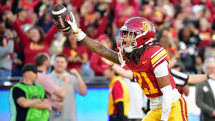 Nov 16, 2024; Los Angeles, California, USA; Southern California Trojans cornerback Greedy Vance Jr. (21) celebrates after intercepting a pass against Nebraska Cornhuskers quarterback Dylan Raiola (15) for the game victory at the Los Angeles Memorial Coliseum. Mandatory Credit: Gary A. Vasquez-Imagn Images