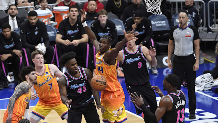 Mar 6, 2026; Charlotte, North Carolina, USA;  Miami Heat guard Davion Mitchell (45) passes to center forward Bam Adebayo (13) against Charlotte Hornets forward center Mousa Diabate (14) during the first half at the Spectrum Center. Mandatory Credit: Sam Sharpe-Imagn Images.