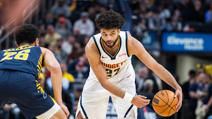 Feb 24, 2025; Indianapolis, Indiana, USA; Denver Nuggets guard Jamal Murray (27) dribbles the ball while Indiana Pacers guard Ben Sheppard (26) defends in the second half at Gainbridge Fieldhouse. Mandatory Credit: Trevor Ruszkowski-Imagn Images