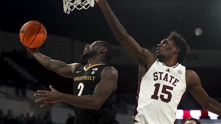 Jan 24, 2026; Starkville, Mississippi, USA; Vanderbilt Commodores guard Duke Miles (2) drives to the basket as Mississippi State Bulldogs center Quincy Ballard (15) defends during the first half at Humphrey Coliseum. Mandatory Credit: Petre Thomas-Imagn Images
