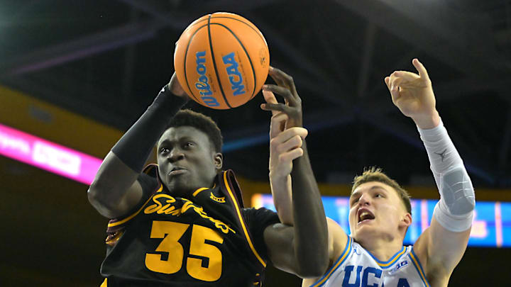 Dec 17, 2025; Los Angeles, California, USA; UCLA Bruins forward Tyler Bilodeau (34) defends Arizona State Sun Devils center Massamba Diop (35) as he drives to the basket in the second half at Pauley Pavilion presented by Wescom Financial. Mandatory Credit: Jayne Kamin-Oncea-Imagn Images 