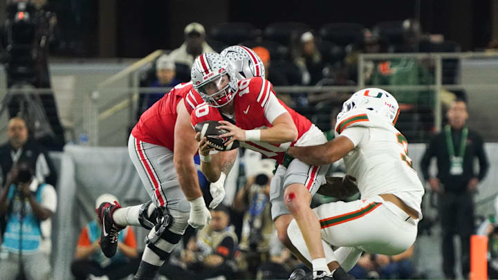 Dec 31, 2025; Arlington, TX, USA; Ohio State Buckeyes quarterback Julian Sayin (10) is sacked by Miami Hurricanes defensive lineman Akheem Mesidor (3) in the second quarter during the 2025 Cotton Bowl and quarterfinal game of the College Football Playoff at AT&T Stadium. Mandatory Credit: Raymond Carlin III-Imagn Images