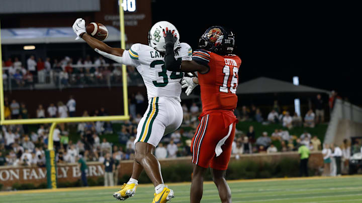 Nov 15, 2025; Waco, Texas, USA; Baylor Bears wide receiver Josh Cameron (34) makes a catch against Utah Utes cornerback Blake Cotton (16) during the second half at McLane Stadium. Mandatory Credit: Chris Jones-Imagn Images