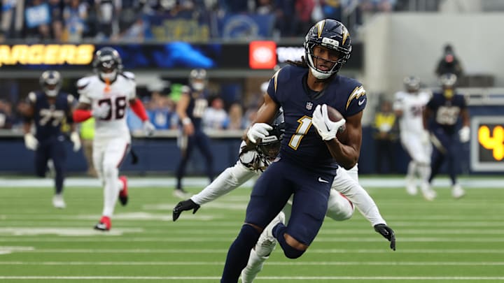 Dec 27, 2025; Inglewood, California, USA;  Los Angeles Chargers wide receiver Quentin Johnston (1) runs after the catch as Houston Texans cornerback Tremon Smith (11) defends during the first half at SoFi Stadium. Mandatory Credit: Kiyoshi Mio-Imagn Images