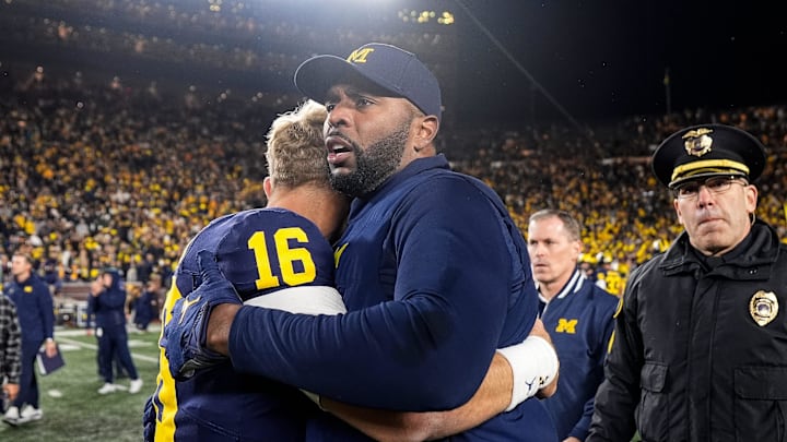 Michigan head coach Sherrone Moore hugs quarterback Davis Warren (16) after 24-17 win over Michigan State at Michigan Stadium in Ann Arbor on Saturday, Oct. 26, 2024.