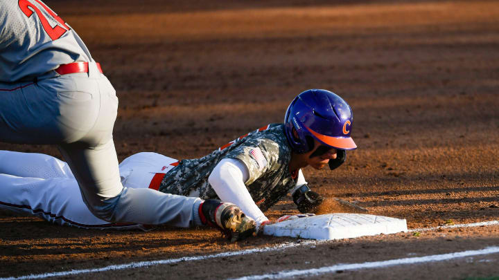 Georgia freshman Charlie Condon (24) attempts to tag out Clemson freshman Nathan Hall (22) at first base during a game at Doug Kingsmore Stadium in Clemson Tuesday, April 18, 2023.