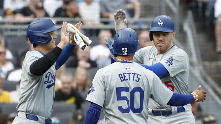 Jun 6, 2024; Pittsburgh, Pennsylvania, USA; Los Angeles Dodgers designated hitter Shohei Ohtani (left) and shortstop Mookie Betts (50) congratulate first baseman Freddie Freeman (5) crossing home plate on a three-run home run against the Pittsburgh Pirates during the first inning at PNC Park. Mandatory Credit: Charles LeClaire-Imagn Images Jun 6, 2024; Pittsburgh, Pennsylvania, USA; Los Angeles Dodgers designated hitter Shohei Ohtani (left) and shortstop Mookie Betts (50) congratulate first baseman Freddie Freeman (5) crossing home plate on a three-run home run against the Pittsburgh Pirates during the first inning at PNC Park. Mandatory Credit: Charles LeClaire-Imagn Images