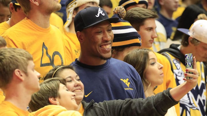 Feb 16, 2015; Morgantown, WV, USA; West Virginia Mountaineers fans take a photograph with West Virginia former defensive end Bruce Irvin (R) before the game against the Kansas Jayhawks at the WVU Coliseum. West Virginia won 62-61. Mandatory Credit: Charles LeClaire-Imagn Images Feb 16, 2015; Morgantown, WV, USA; West Virginia Mountaineers fans take a photograph with West Virginia former defensive end Bruce Irvin (R) before the game against the Kansas Jayhawks at the WVU Coliseum. West Virginia won 62-61. Mandatory Credit: Charles LeClaire-Imagn Images
