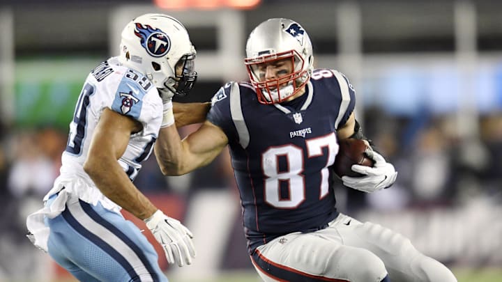 New England Patriots tight end Rob Gronkowski (87) attempts to push off Tennessee Titans linebacker Wesley Woodyard (59) after a big gain during the AFC Divisional Round playoff game at Gillette Stadium in Foxborough, Mass., Jan. 13, 2018. New England Patriots tight end Rob Gronkowski (87) attempts to push off Tennessee Titans linebacker Wesley Woodyard (59) after a big gain during the AFC Divisional Round playoff game at Gillette Stadium in Foxborough, Mass., Jan. 13, 2018.