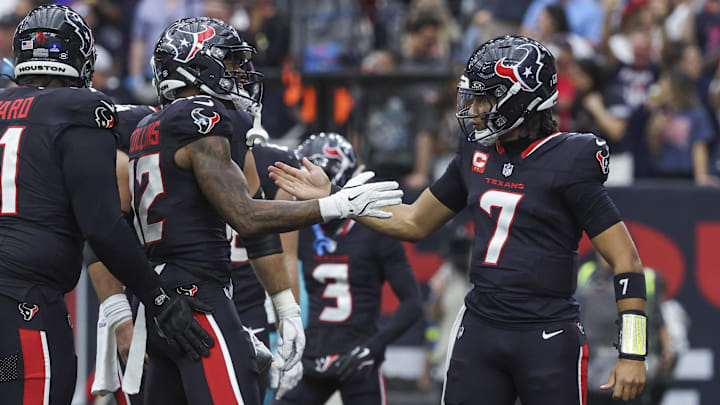 Dec 15, 2024; Houston, Texas, USA; Houston Texans wide receiver Nico Collins (12) celebrates with quarterback C.J. Stroud (7) after a touchdown reception during the second quarter against the Miami Dolphins at NRG Stadium. Mandatory Credit: Troy Taormina-Imagn Images
