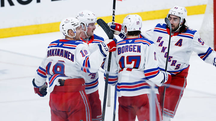 Mar 12, 2026; Winnipeg, Manitoba, CAN; New York Rangers forward Alexis Lafreniere (13) is congratulated by his team mates on his goal against Winnipeg Jets goalie Connor Hellebuyck (37) during the second period at Canada Life Centre. Mandatory Credit: Terrence Lee-Imagn Images