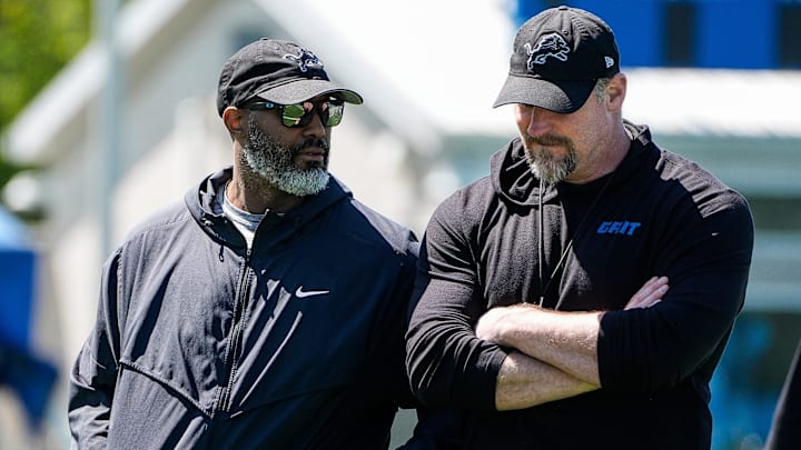Detroit Lions general manager Brad Holmes, left, talks to head coach Dan Campbell as they walk off the field after practice 