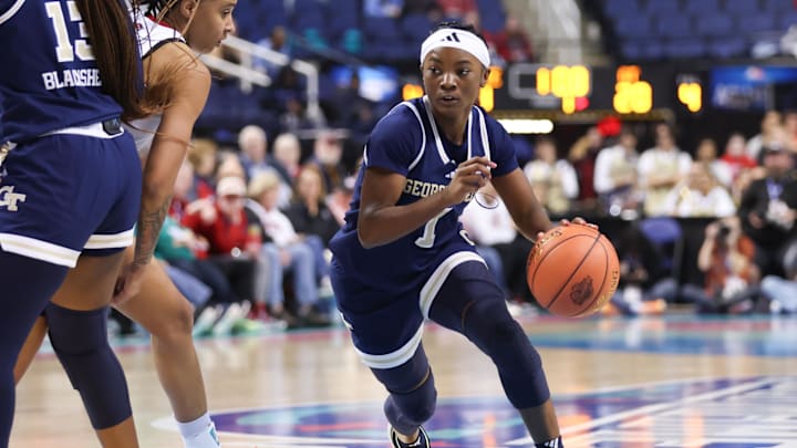 Mar 7, 2025; Greensboro, NC, USA;  Georgia Tech Yellow Jackets guard Chazadi Wright (1) drives to the basket against NC State Wolfpack during the first quarter at First Horizon Coliseum. Mandatory Credit: Cory Knowlton-Imagn Images