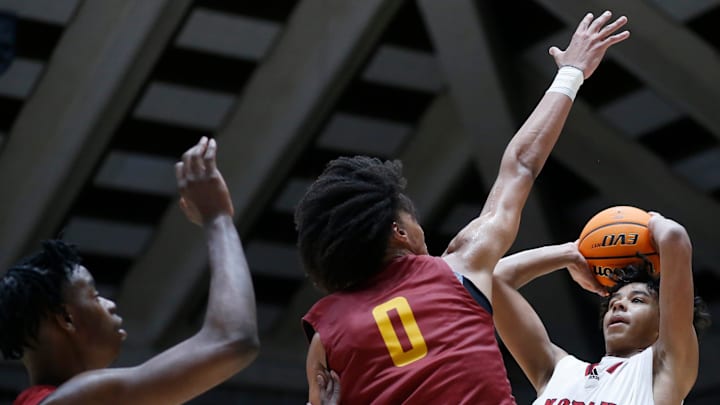 North Oconee's Justin Wise (2) takes a shot while being defended by Holy Innocents Episcopal's Will Hopkins (0) and Holy Innocents Episcopal's Caleb Wilson (24) during the GHSA high school basketball AAAA Region 8 championship game in Macon, Ga., on Wednesday, March 6, 2024. North Oconee won 65-60.