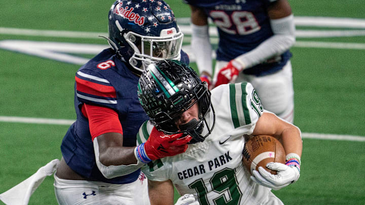 Denton Ryan sophomore linebacker Anthony Hill Jr. (6) grabs the face mask of Cedar Park senior wide receiver Jack Hestera (19) during the first half of a state championship high school football game on Friday, Jan. 15, 2021 at AT&T Stadium in Arlington, Texas.